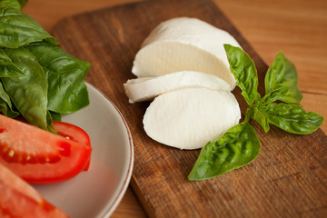 Caprese Salad. Tomato and Mozzarella slices with basil leaves.