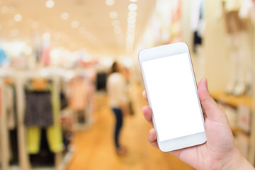 woman using Cell phone in clothing store