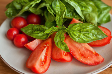 Caprese Salad. Tomato and Mozzarella slices with basil leaves.
