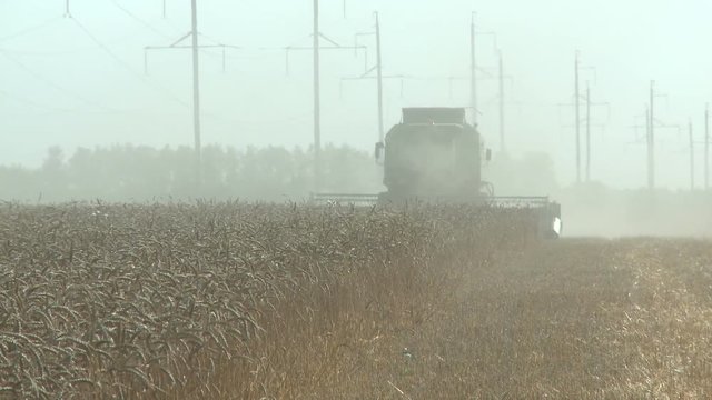 working harvesting combine in the dust field