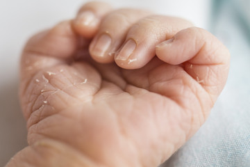 Tiny small baby newborn hand close up