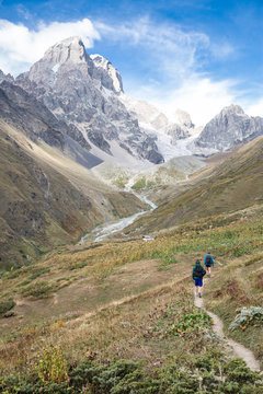 Rear view of male hikers in mountain landscape, Ushba, Svaneti, Georgia