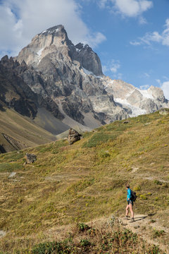 Male hiker looking out at mountain landscape, Ushba, Svaneti, Georgia