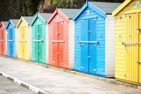 Row of multicolored wooden beach huts,  Devon, UK
