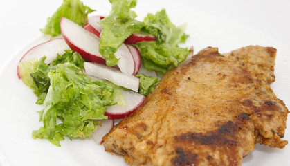Steak meat grilled with salad made with radish, fresh lettuce an