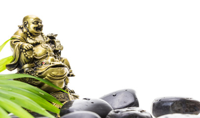 Laughing Buddha and stack of black basalt stones, on white background.