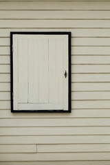 White wooden window on vintage wood wall.