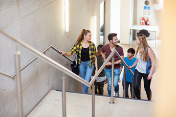 Group of students moving up stairway at higher education college