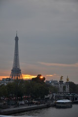 The sun setting behind the Eiffel Tower - Paris, France