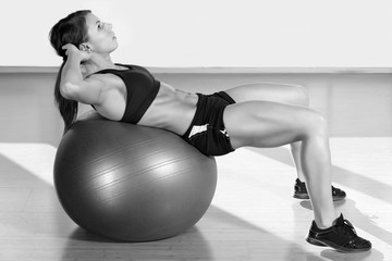 Young attractive woman doing abs workout