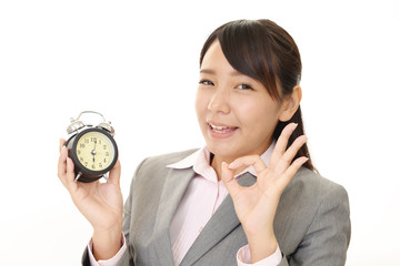 時計を持つ笑顔のビジネスウーマン