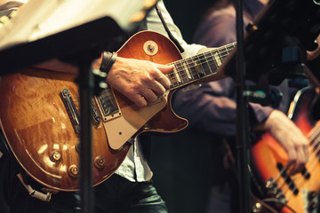 Guitar players on a stage, selective focus