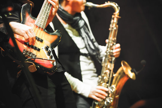Guitar player and saxophonist on a stage