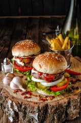 Two burgers on wood table