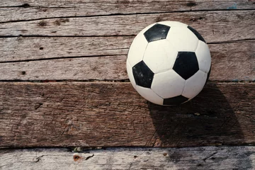 Photo sur Aluminium Sports de balle Soccer ball on old wooden floor, Copy space