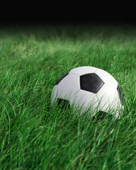 Fototapeta na wymiar Soccer football on grass field, Soccer ball in fresh green summer or spring field grass
