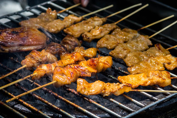 Grilled chicken on the flaming grill