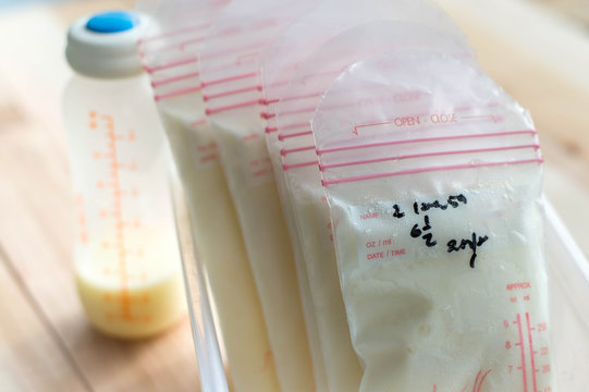 breast milk frozen in storage bags for baby with sunlight, Selective focus
