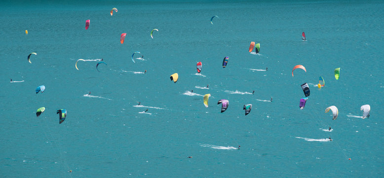 Large group of kitesurfers on turquoise lake, Canton Graubunden, Switzerland