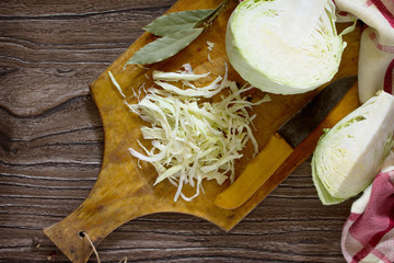 Sliced ​​cabbage on old wooden table. Young green cabbage. I