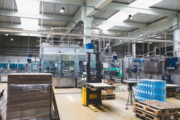 Industrial interiors. Robotic factory line for processing and quality control of pure spring water bottled into canisters. 