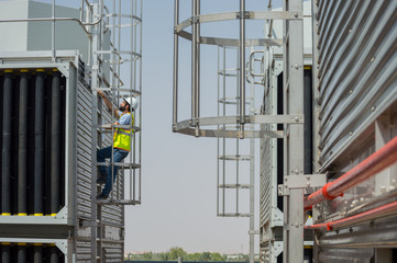 Mechanical engineer during a site visit, checking cooling towers installation