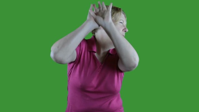 Mature woman showing anger emotion on green screen.
