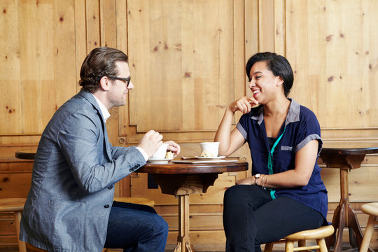 Man and woman sitting in cafe drinking coffee