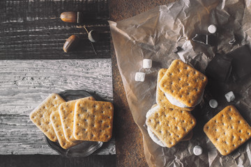 Smores with ingredients on the different background top view
