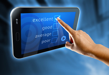 A woman's finger answer a online survey on a digital tablet