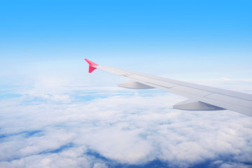 Aircraft wing on the clouds, flying background
