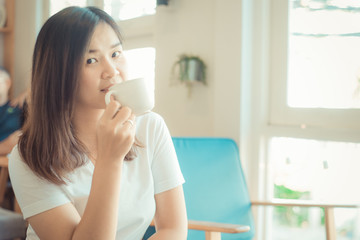 Woman drinking hot latte coffee white cup sitting on sofa cozy r