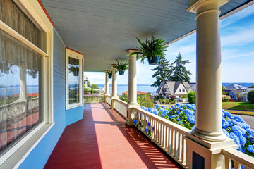 Wooden walkout porch of craftsman American house in blue tones