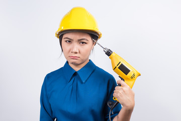 Young builder woman with a drill
