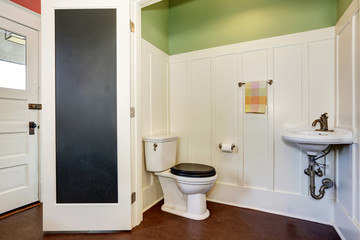 Fototapeta na wymiar Classic bathroom interior with toilet and sink. Also green and white walls.