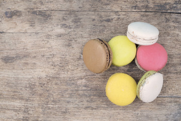 Sweet and colourful french macaroons on retro vintage wooden bac