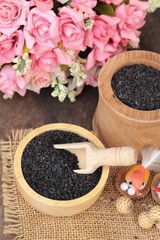 Poppy seeds of organic on wood background.