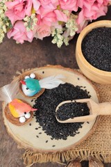 Poppy seeds of organic on wood background.