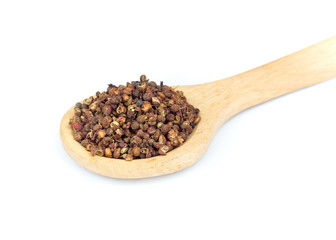 Zanthozylum limonella Alston on wooden spoon over white background