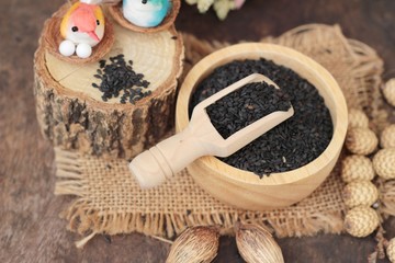 Poppy seeds of organic on wood background.
