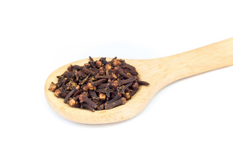 Spice cloves on wooden spoon over white background