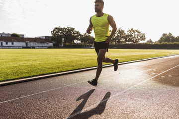 Athlete running on tartan track