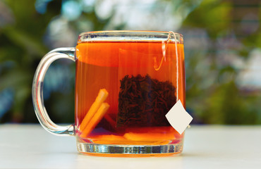 Black tea with a slice of lemon in a glass mug