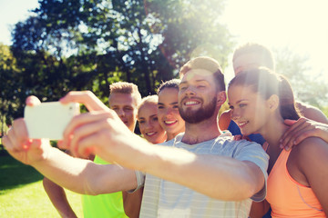 happy friends taking selfie with smartphone