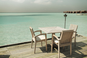 Fototapeta na wymiar outdoor restaurant terrace with furniture over sea