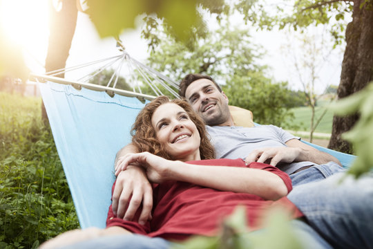 Smiling couple relaxing in hammock