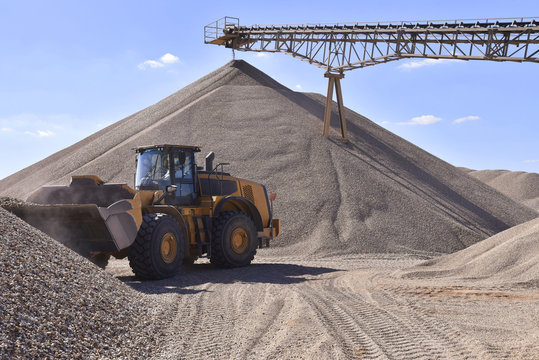 Wheel loader loading gravel in gravel pit