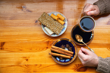 morning Breakfast with coffee and sweets. The texture of the wooden table. Man eating Breakfast. The view from the top