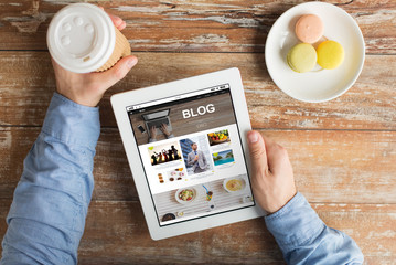 close up of hands with internet blog on tablet pc