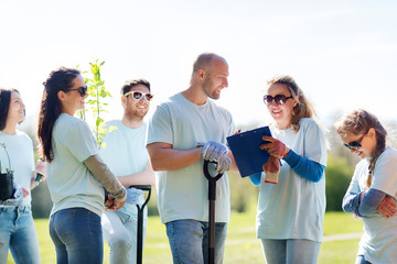 group of volunteers planting trees in park